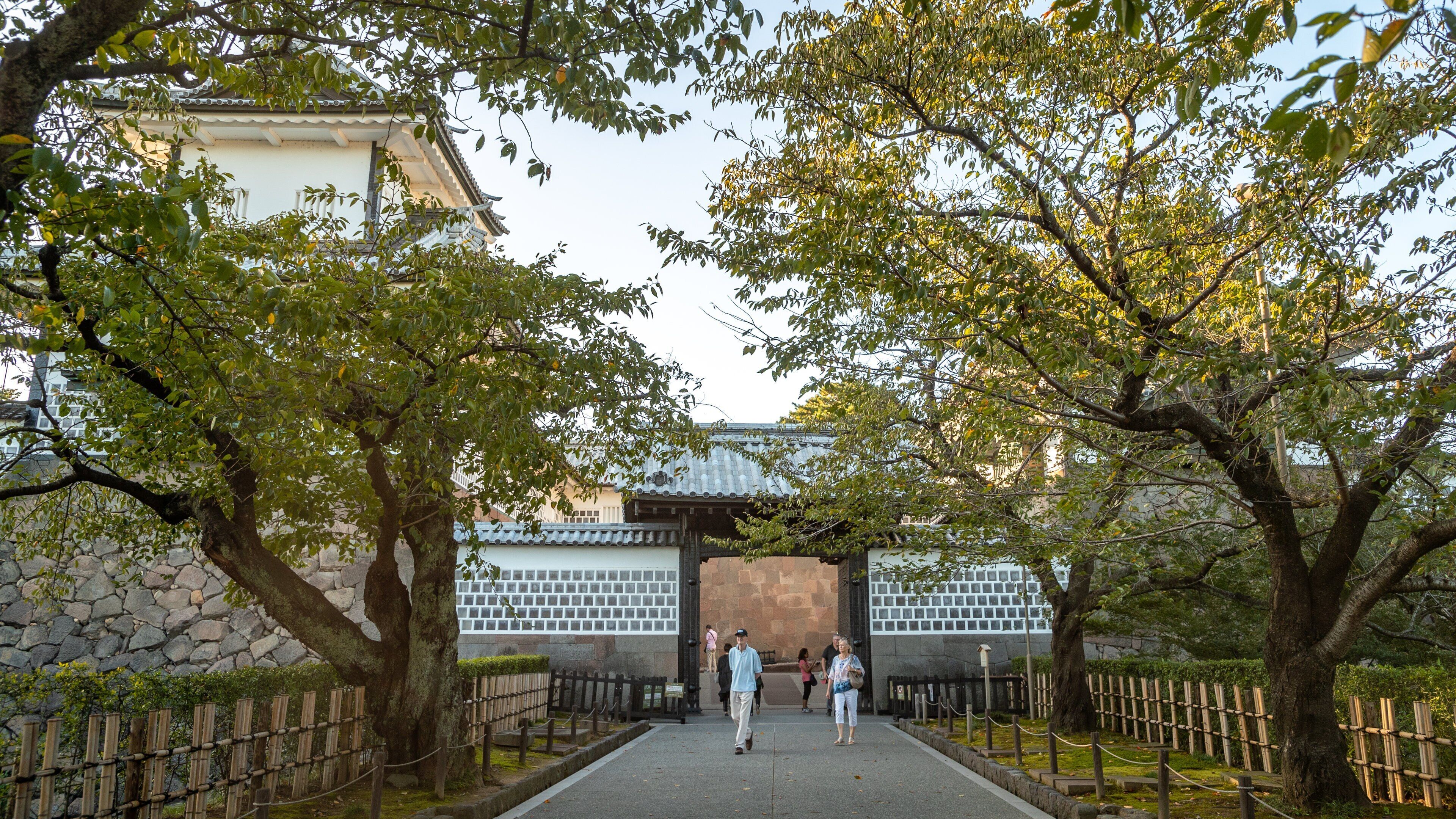 Kanazawa Castle showing a park as well as a couple