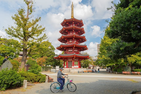 Kawasaki Daishi featuring heritage architecture and cycling as well as an individual male