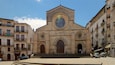 A historic church with a large central dome and arched doorways, surrounded by traditional buildings.