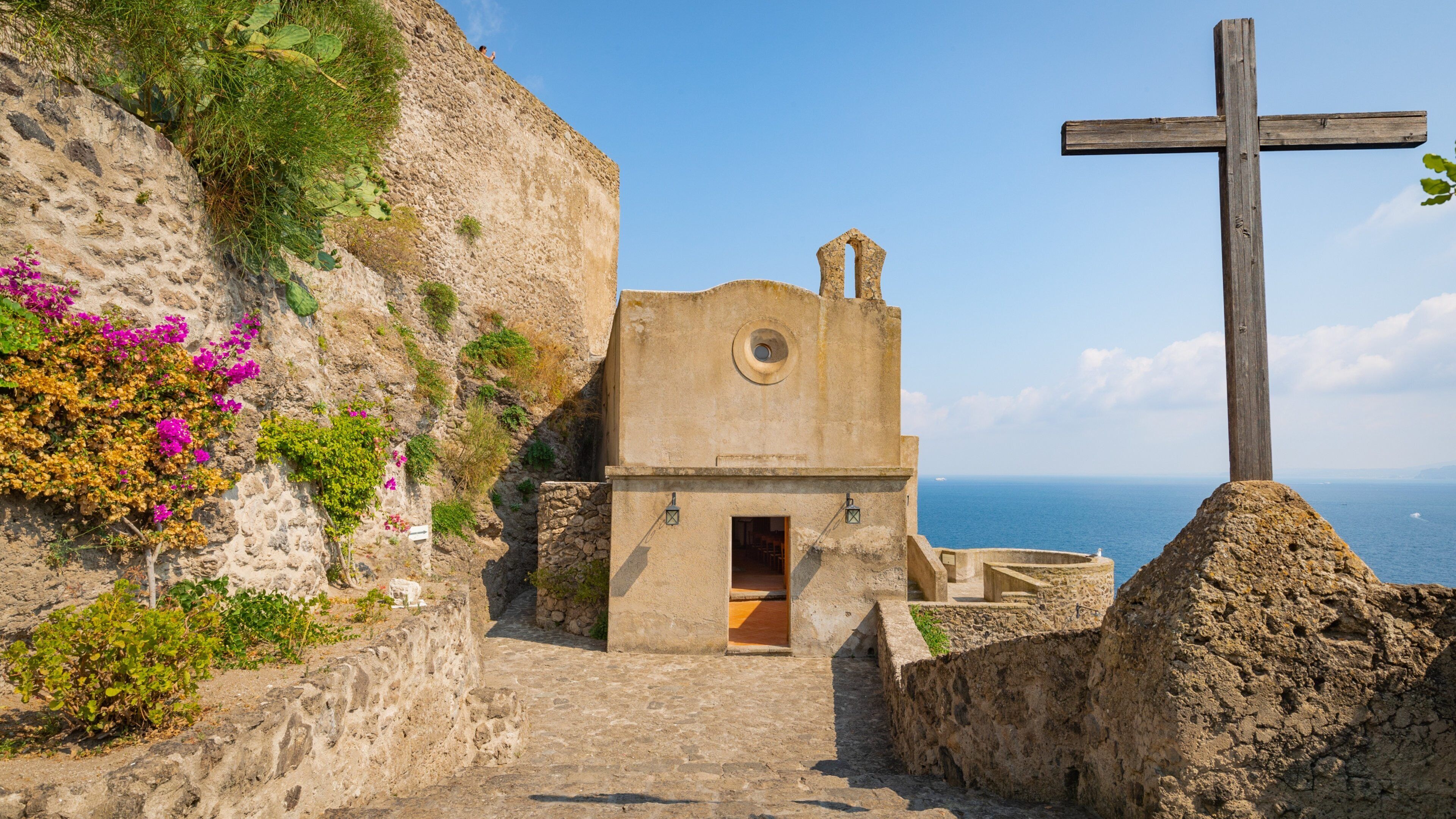 Aragonese Castle which includes general coastal views, heritage elements and religious elements