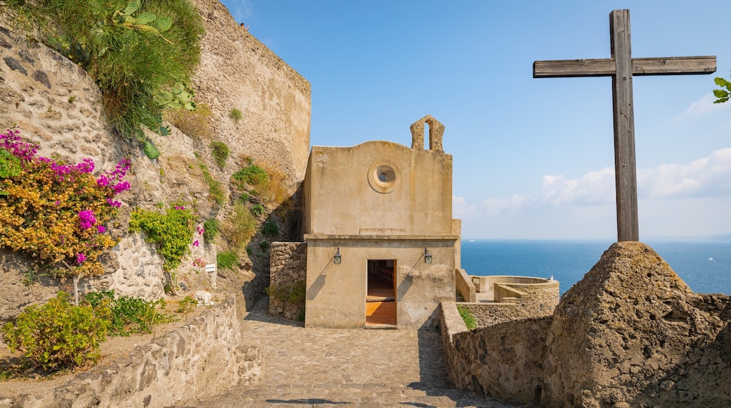 Aragonese Castle which includes general coastal views, heritage elements and religious elements