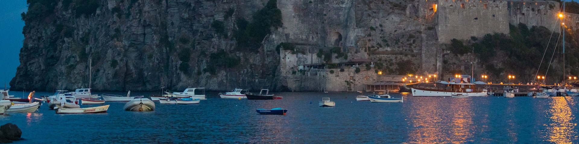 Aragonese Castle which includes general coastal views, night scenes and heritage elements