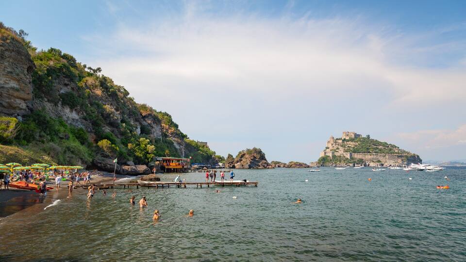 A coastal scene with a rocky cliff, a beach with umbrellas, and a castle on a hill.