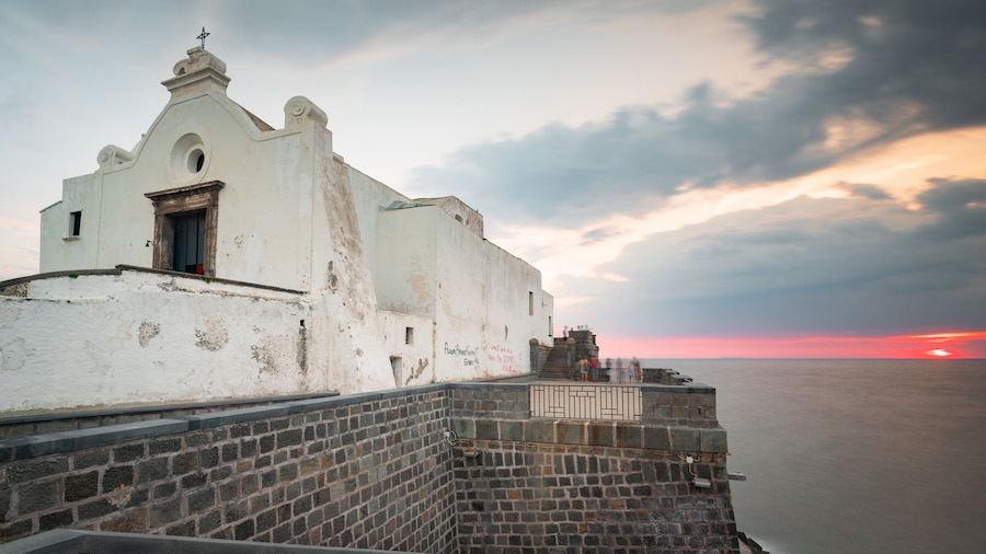 Soccorso Church which includes a sunset, heritage architecture and general coastal views