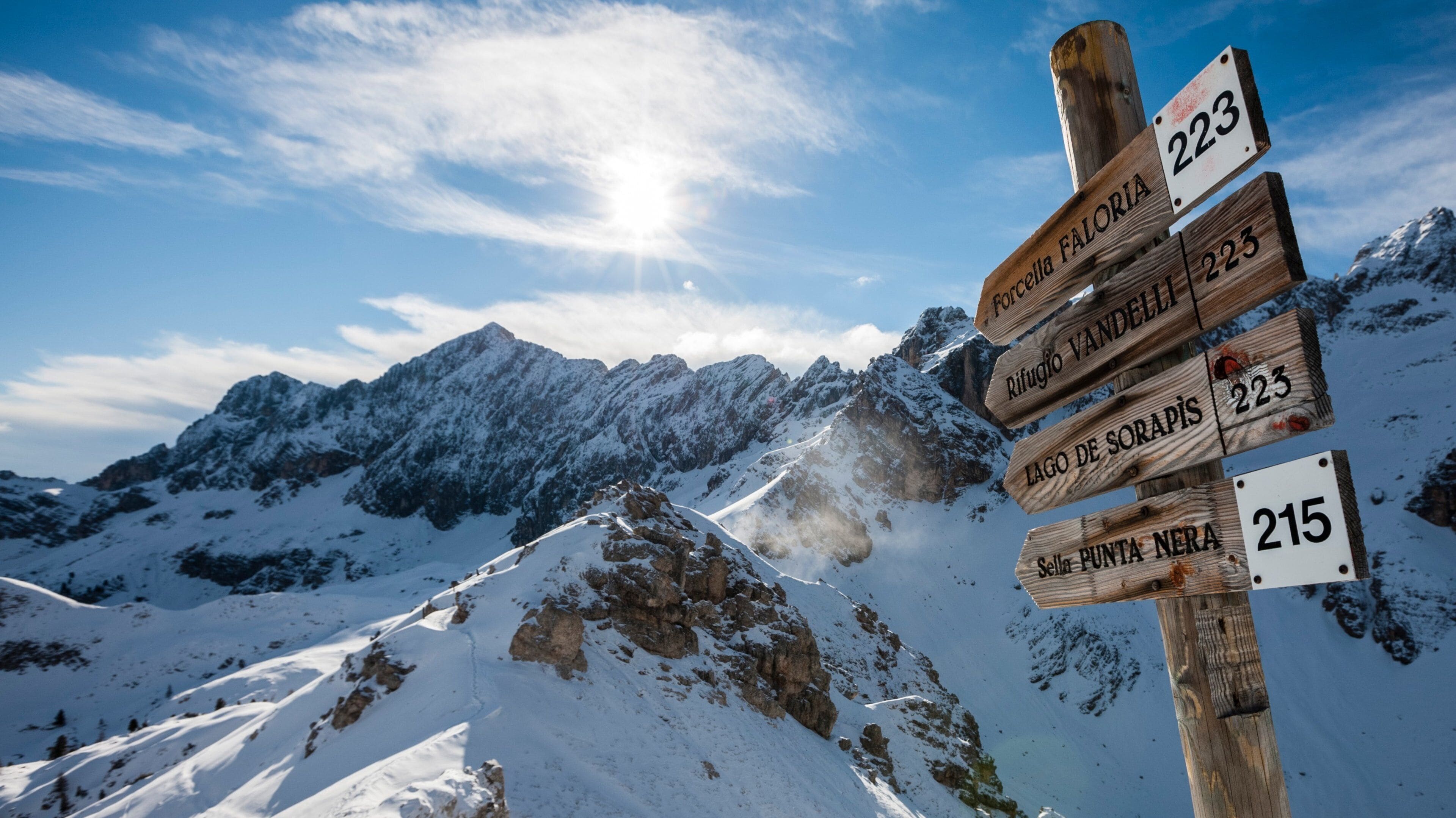 Cortina d\'Ampezzo Ski Resort featuring signage, mountains and snow