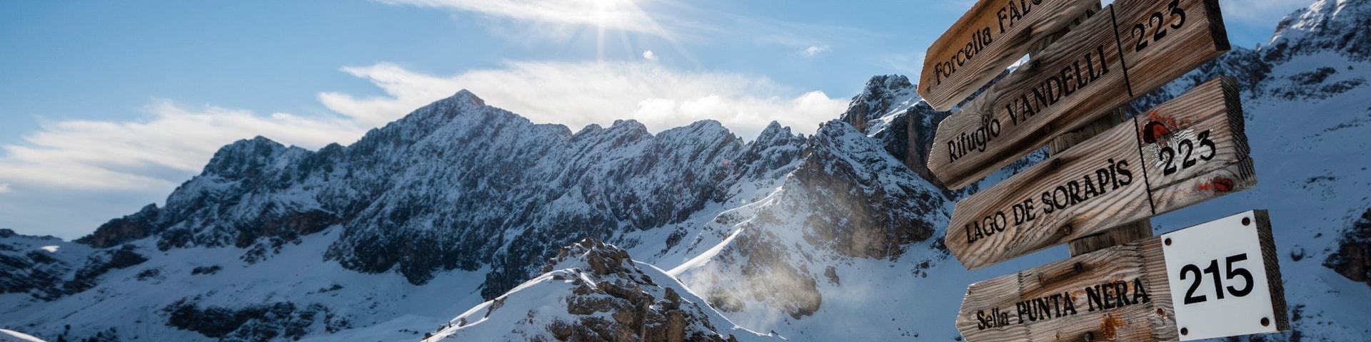 Cortina d\'Ampezzo Ski Resort featuring signage, mountains and snow