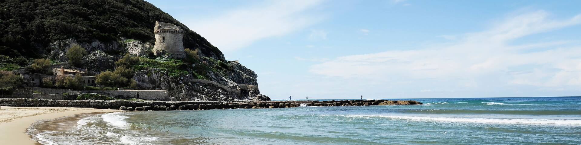 Horizontal banner or header with ancient defense tower Torre Paola on a hill near the Mediterranean Sea in the Circeo National Park. Coast of Lungomare di Sabaudia, Lazio region in central Italy.