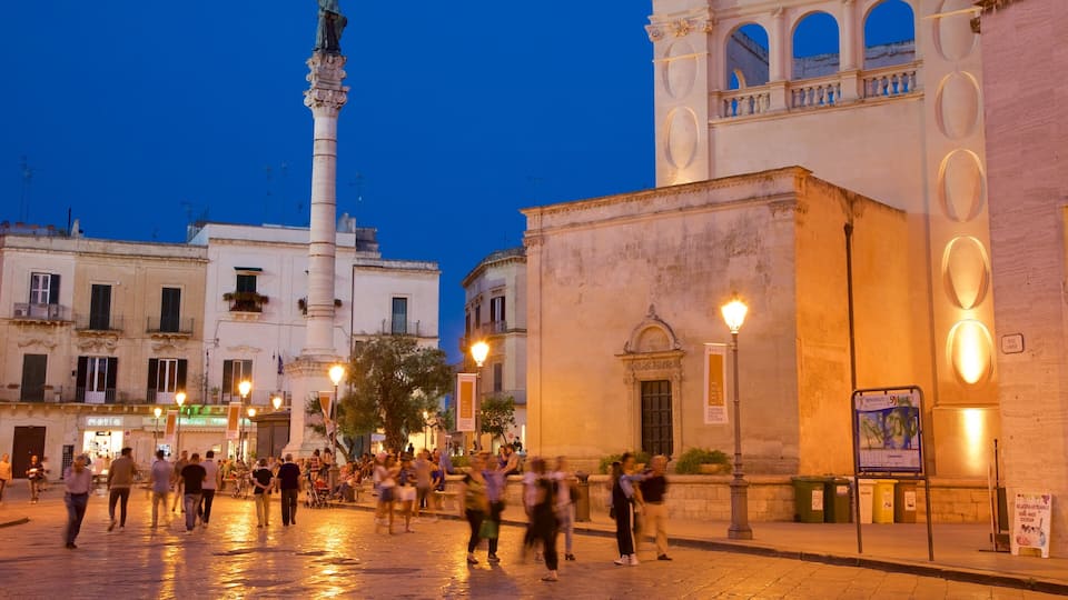 Piazza Sant\'Oronzo featuring night scenes and heritage architecture