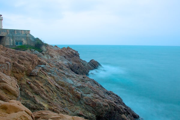 Castello del Boccale featuring rocky coastline and château or palace