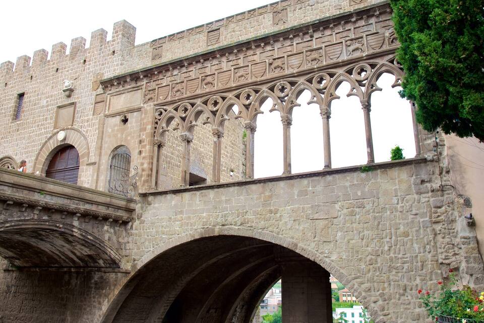 A historic stone building with arched windows and intricate carvings.