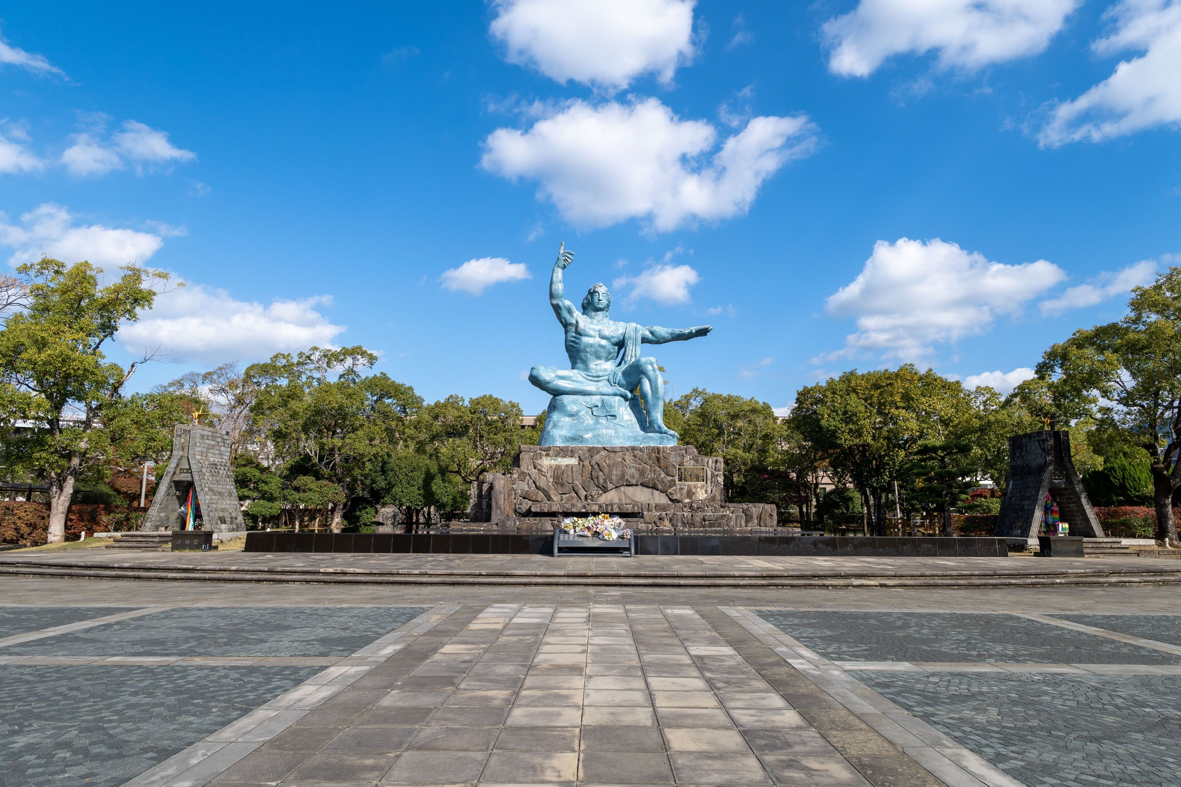 Peace Statue in the Peace Park, Nagasaki surrounded  by lush trees
