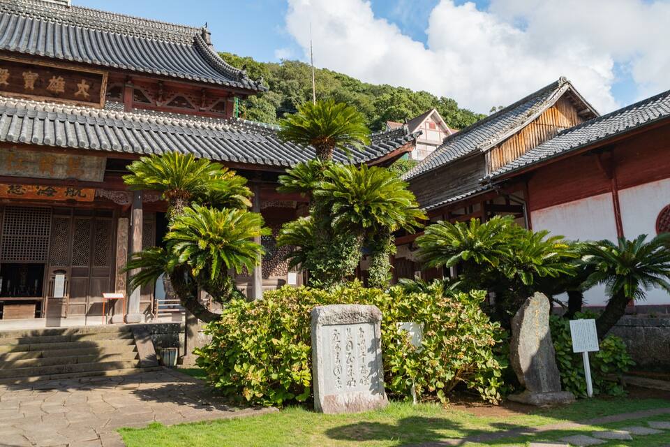 Traditional East Asian architecture with tiled roofs and wooden structures.