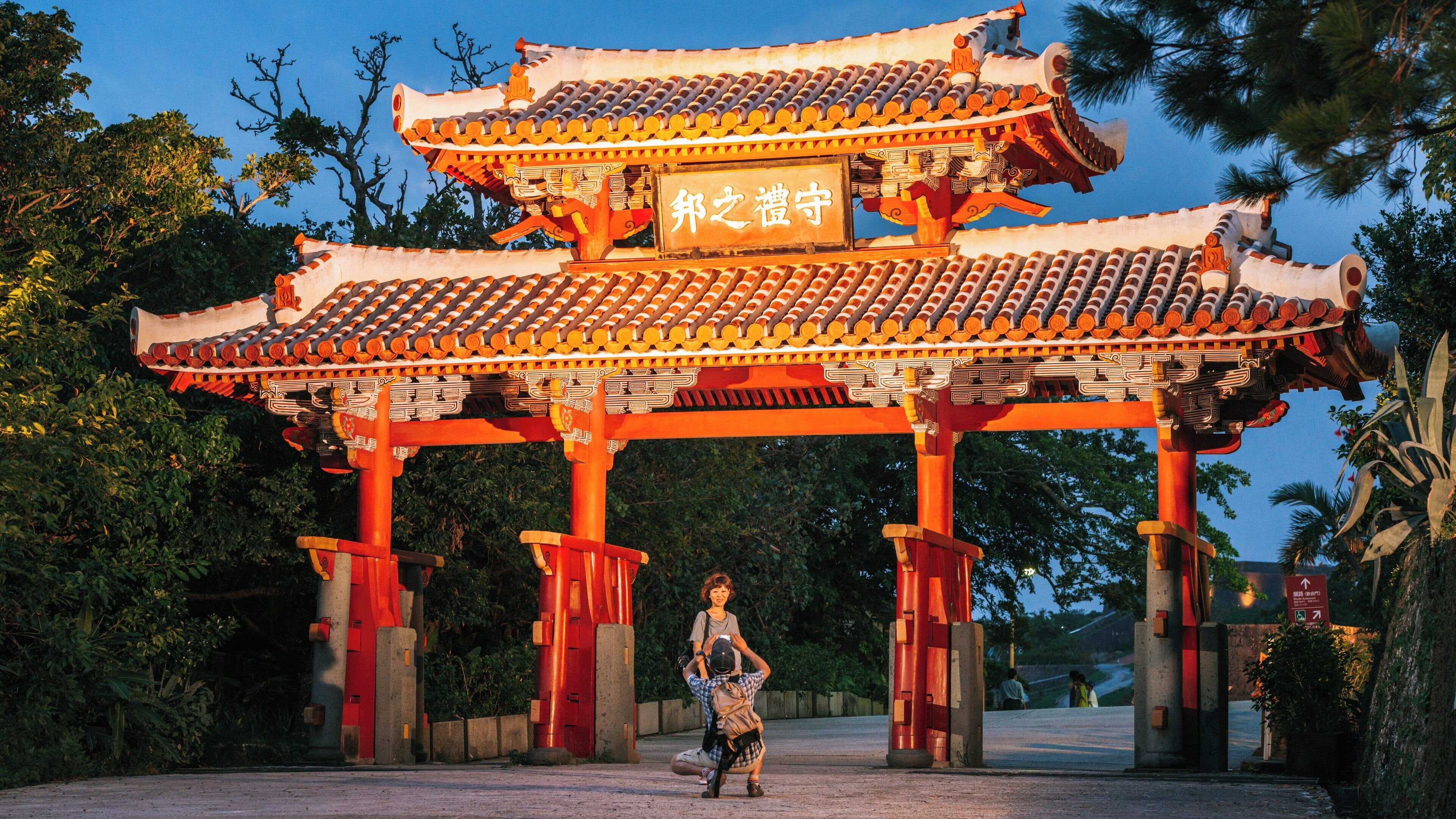 Explore Shurijo Castle in Naha, Okinawa during twilight, showcasing its vibrant architectural details and historical significance