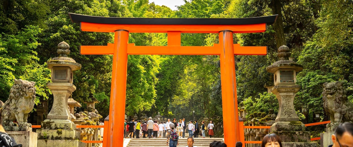 Kasuga Shrine featuring a garden and heritage elements as well as a small group of people