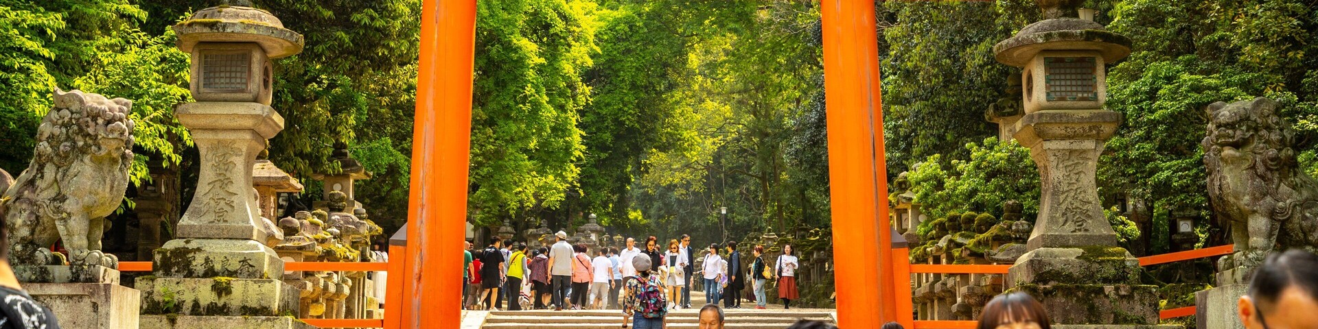 Kasuga Shrine featuring a garden and heritage elements as well as a small group of people