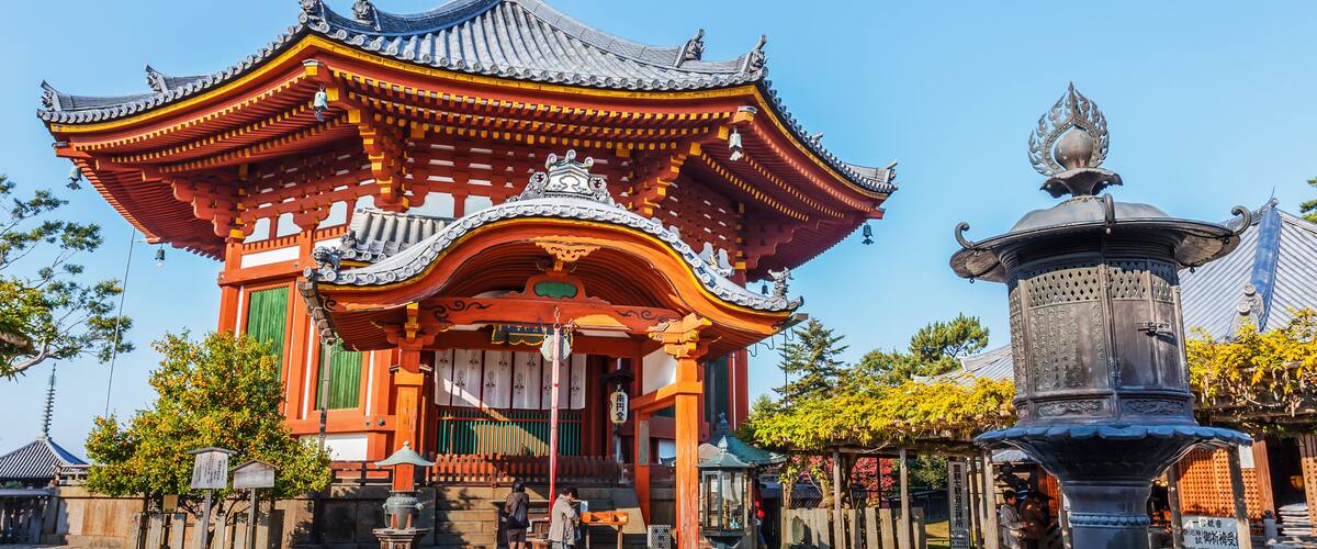 A traditional Japanese temple with a curved roof and ornate decorations.