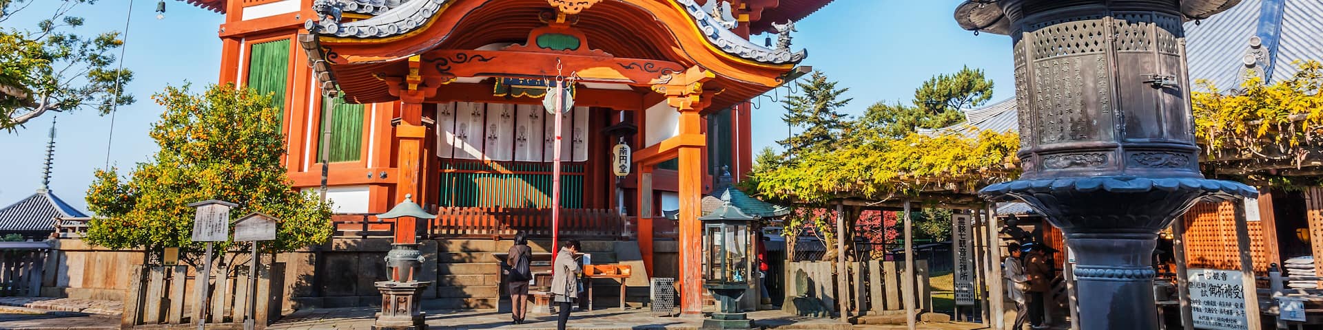 A traditional Japanese temple with a curved roof and ornate decorations.