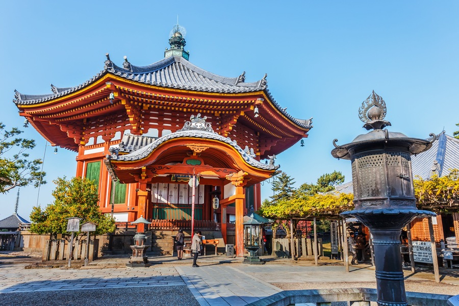 A traditional Japanese temple with a curved roof and ornate decorations.