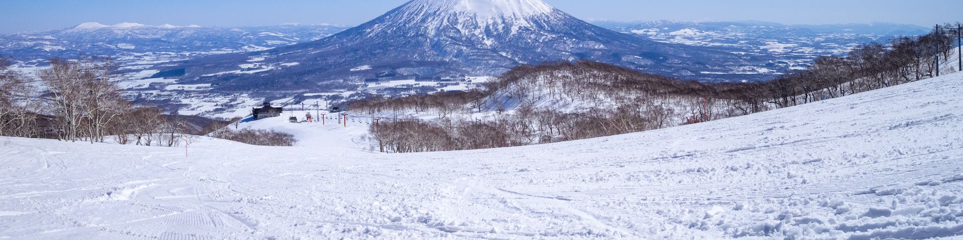 A snow-covered mountain with a clear sky.