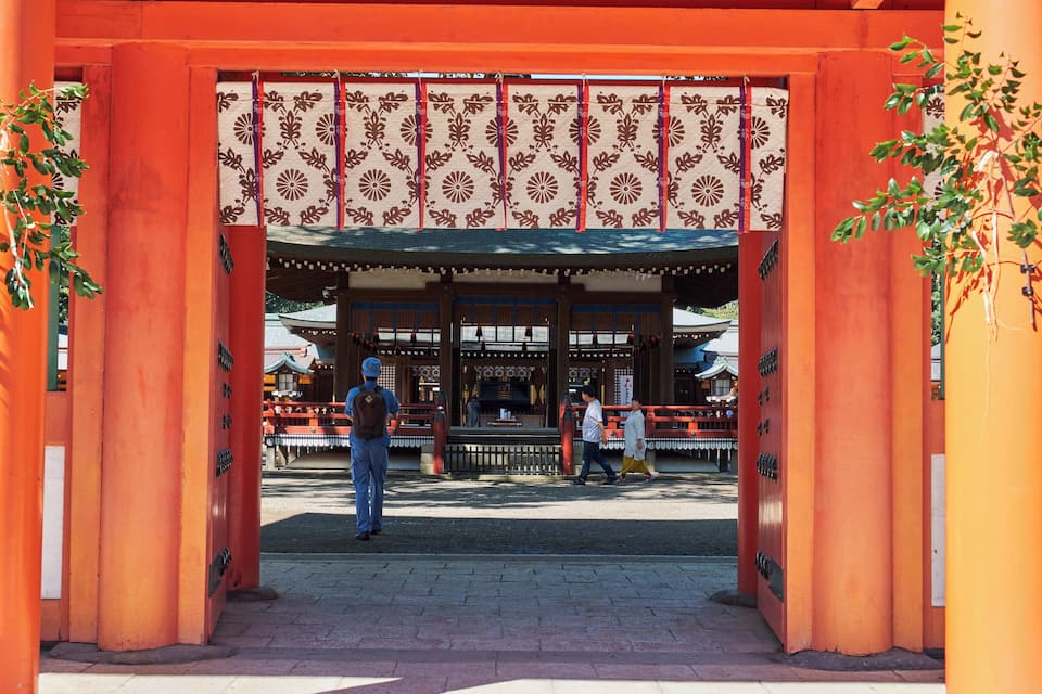 A traditional Japanese torii gate with a patterned canopy.