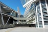 A modern architectural structure with a sign reading "SAITAMA SUPER ARENA".