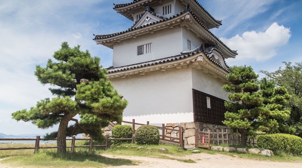Low angle shot of the magnificent Uwajima Castle captured under the blue sky in Japan