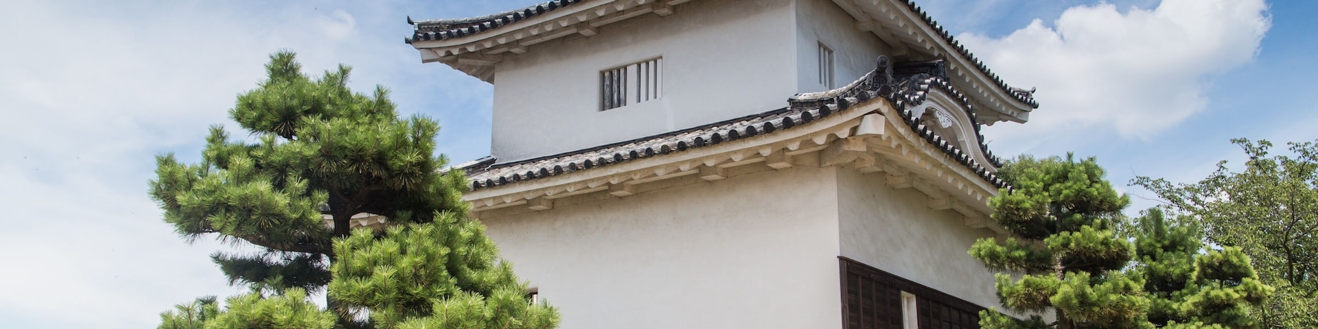 Low angle shot of the magnificent Uwajima Castle captured under the blue sky in Japan