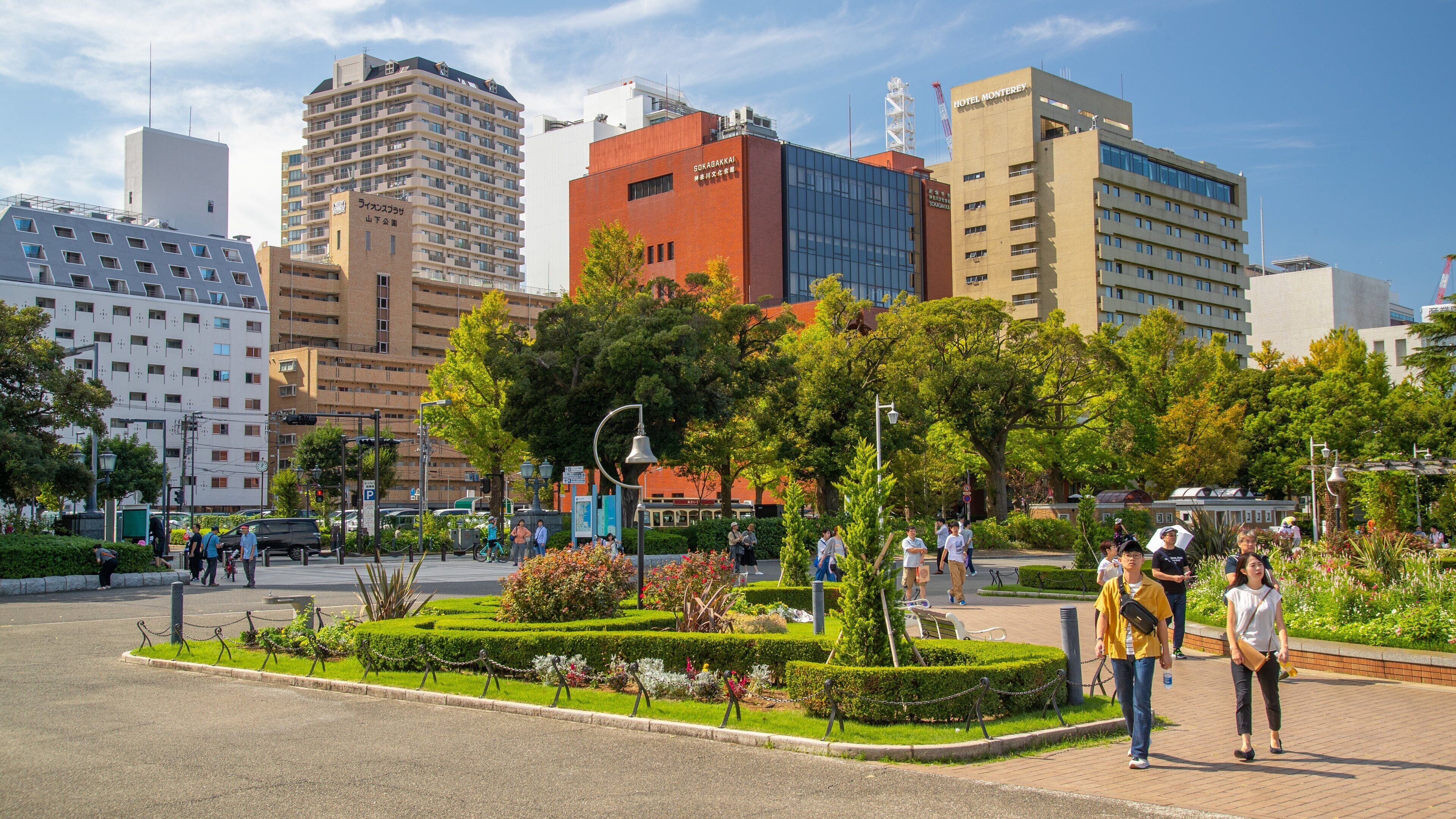 Yamashita Park which includes street scenes and a garden as well as a couple