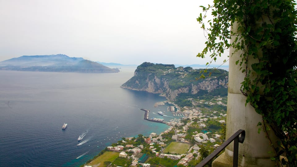 A coastal town with a prominent cliff, a pier, and a ship in the water.