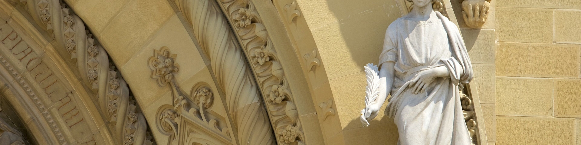 Cathedral of Arezzo featuring a statue or sculpture, a church or cathedral and religious elements