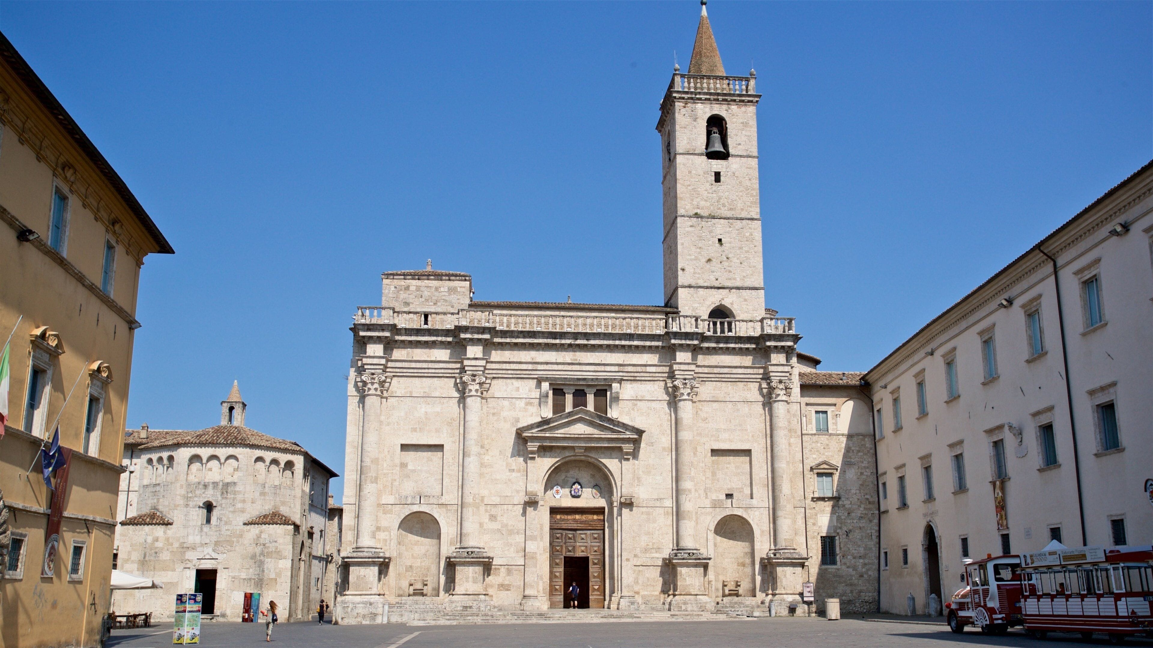 Una iglesia histórica con un alto campanario y una amplia entrada en arco.