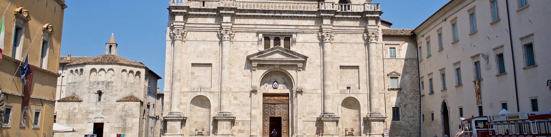 A historic church with a tall bell tower and a large arched entrance.