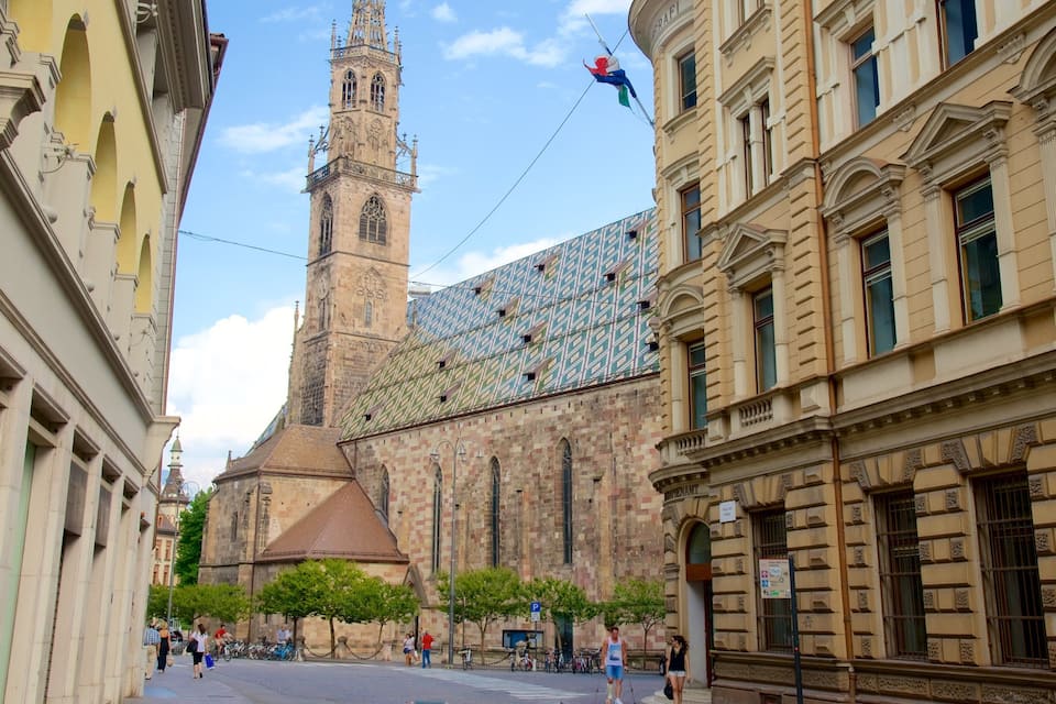 A historic church with a tall tower and a patterned facade.