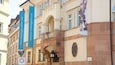 A historic building with a sign for the Südtiroler Archäologiemuseum.
