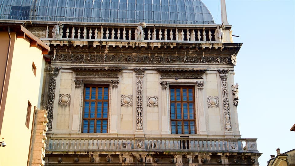 A building with ornate columns, large windows, and intricate carvings.