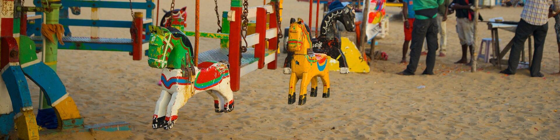 A beach with colorful swings and a 'Lucky Game' sign.