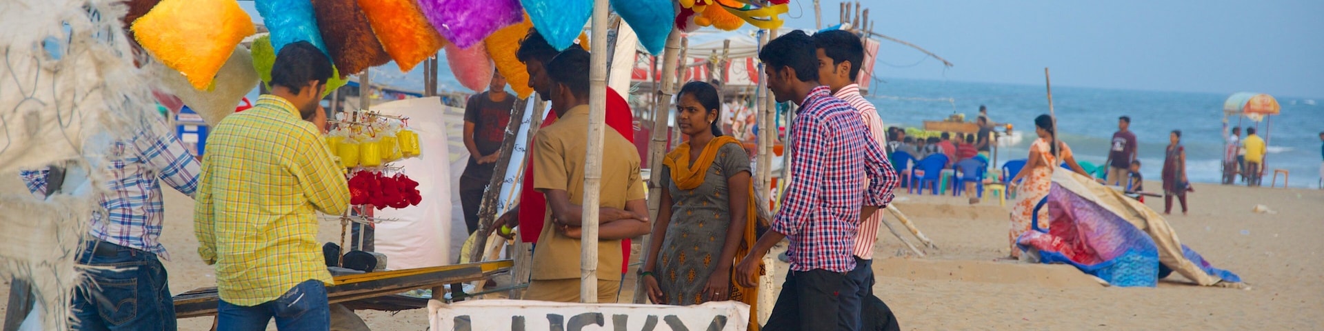 Elliot\'s Beach featuring a sandy beach as well as a small group of people