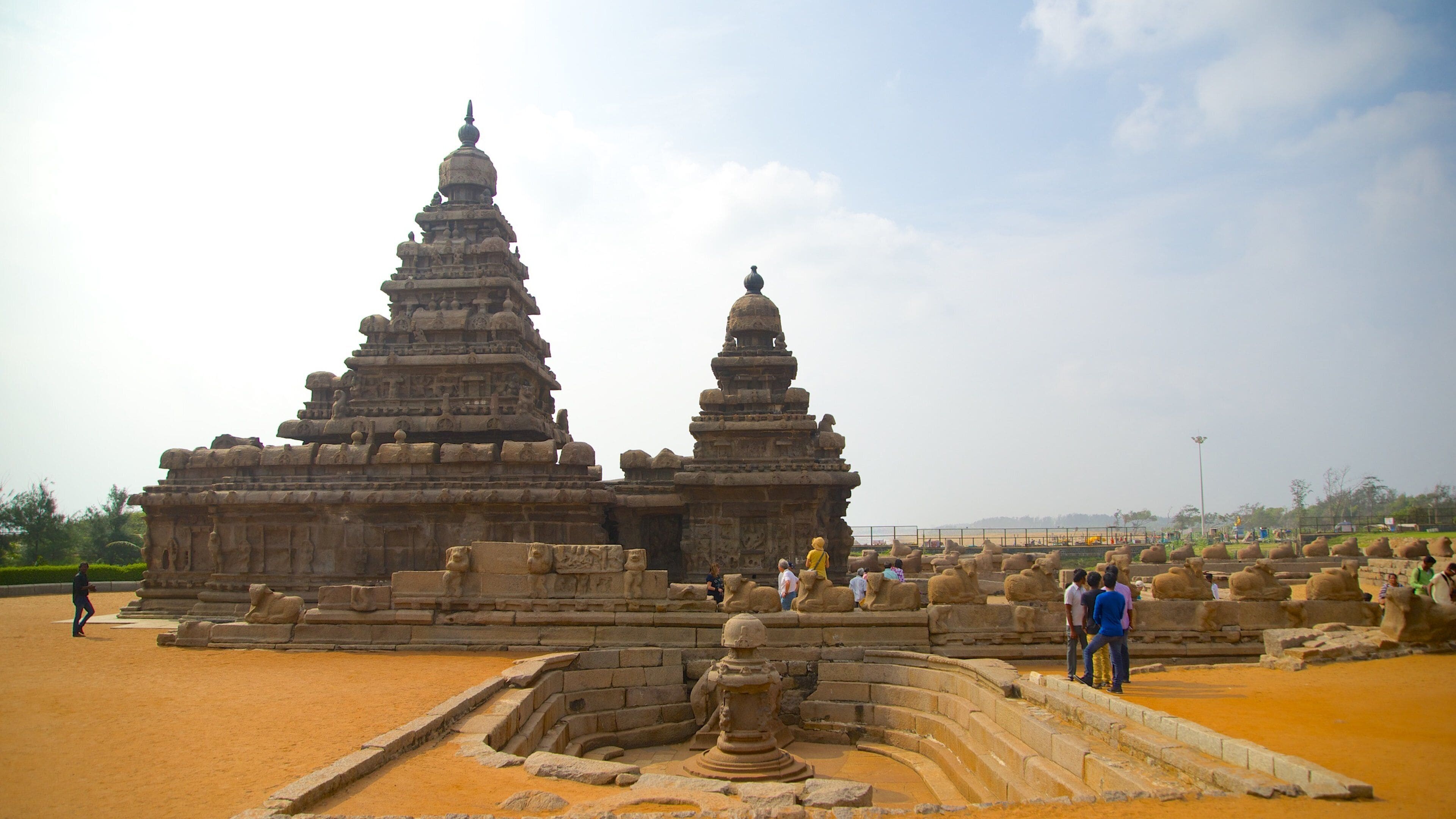 A large stone temple with multiple tiers and a central spire.