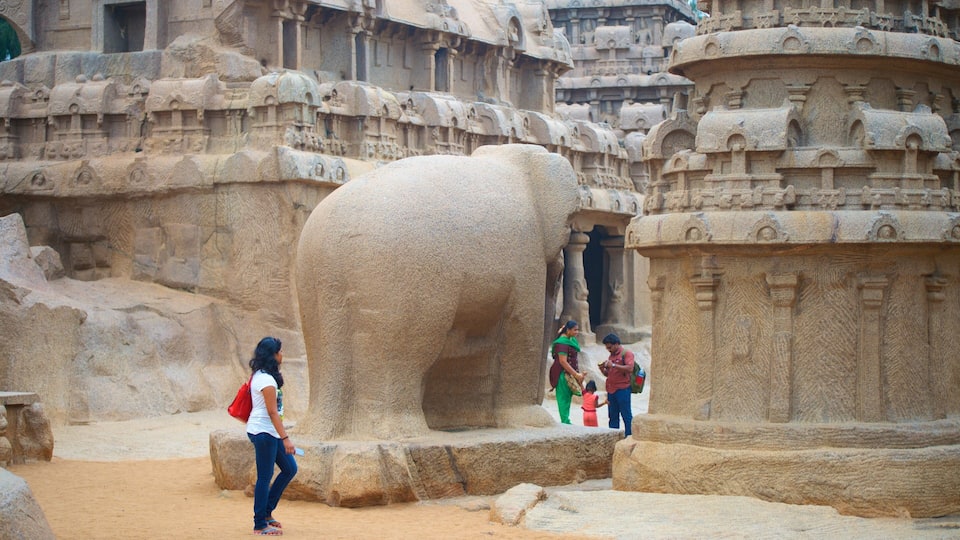 A large stone elephant sculpture in an ancient temple complex.