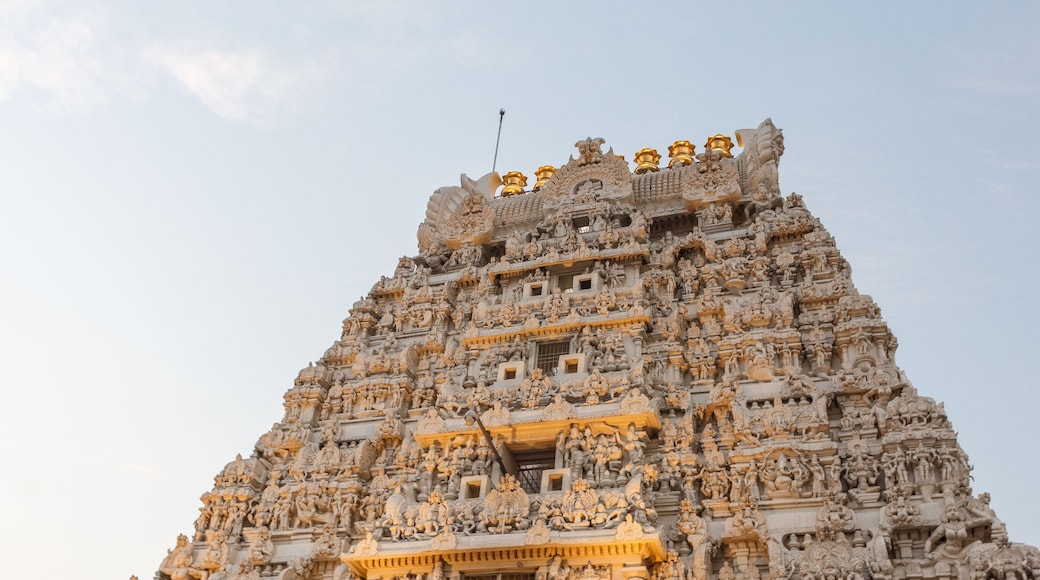 Ancient temple tower view of Kanchi kamakshi amman temple illuminated with lights. Low light photography during sunset.
