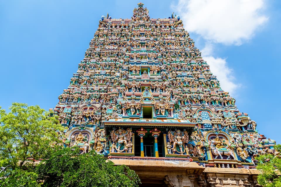 A detailed temple with multiple tiers, ornate carvings, and a prominent entrance.