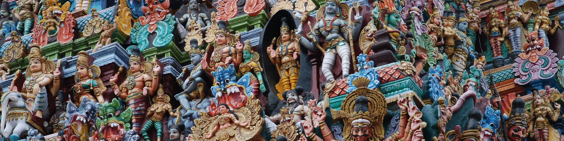 A detailed temple facade with multiple colorful statues of deities.