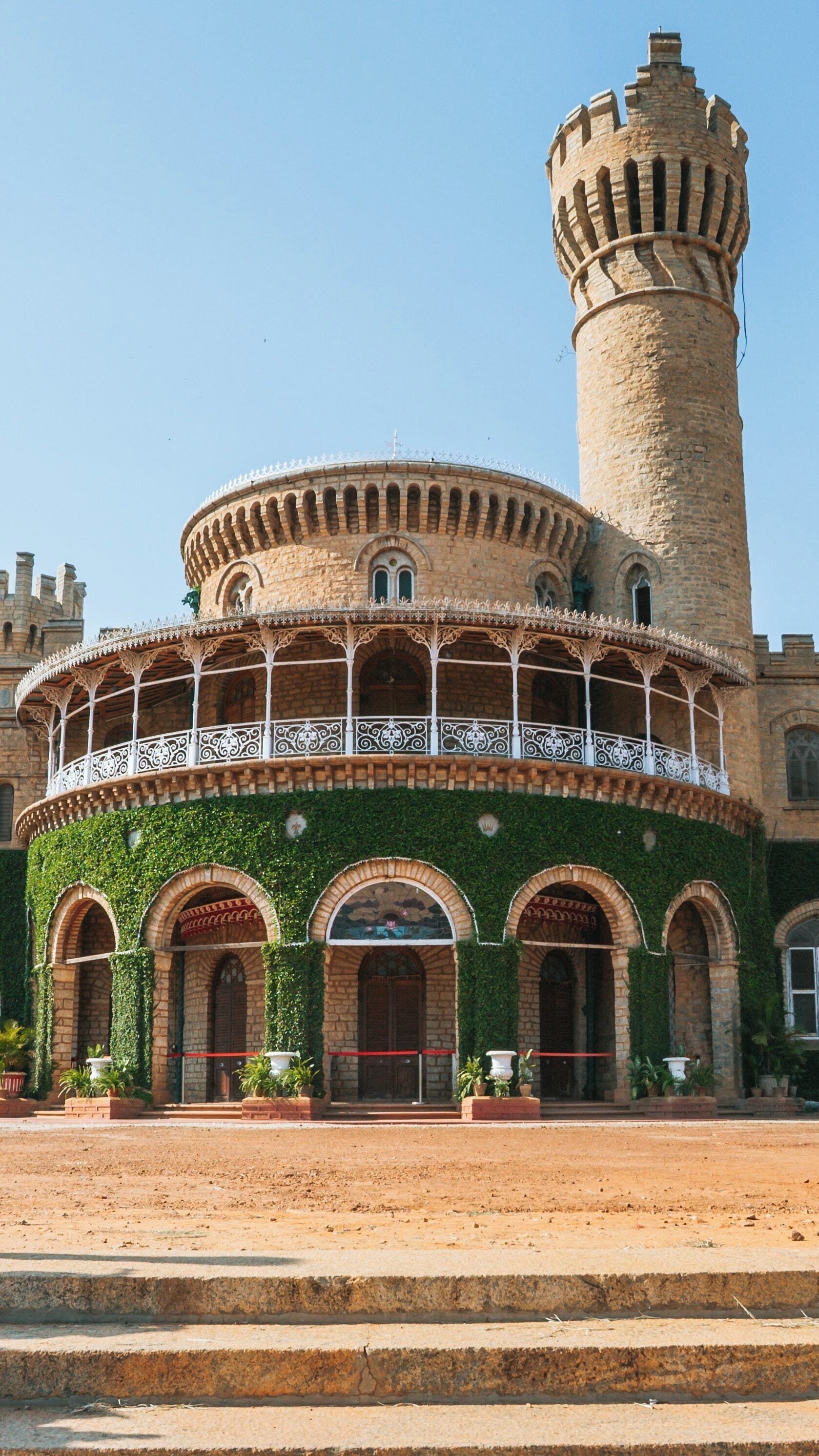 Explore the architectural beauty of Bangalore Palace in Bengaluru, Karnataka during a clear sunny day showcasing its unique design and surrounding greenery