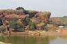 The Agastya Lake is surrounded by hills and reddish sandstone temples, said to have been built in 5th century. The waters of this lake are said to possess healing powers too. The sandstone rocks around this lake have gaps in them that act as pathways to climb up the nearby hill. This view is from Badami caves.