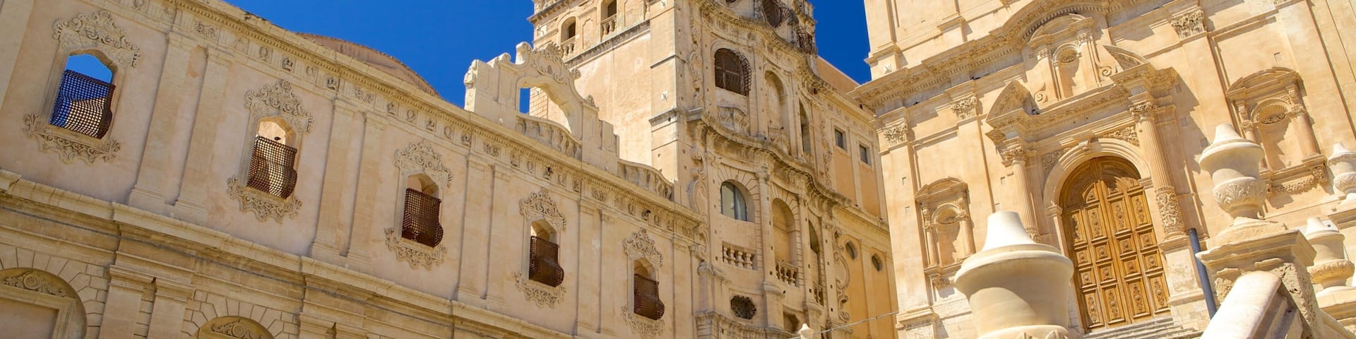 A historic building with ornate architecture, including a bell tower and a large wooden door.