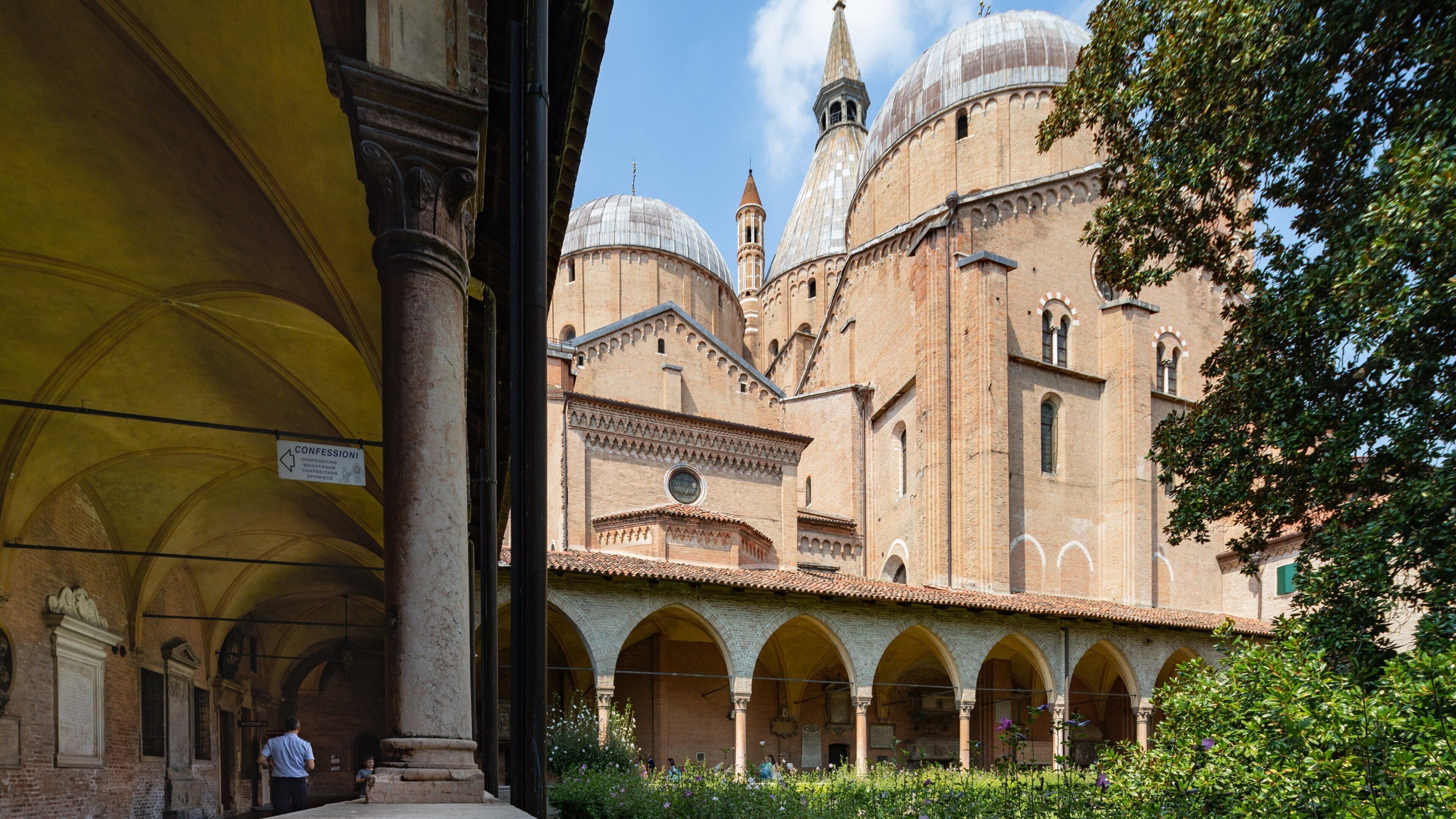 A historic building with arched walkways and domed structures.