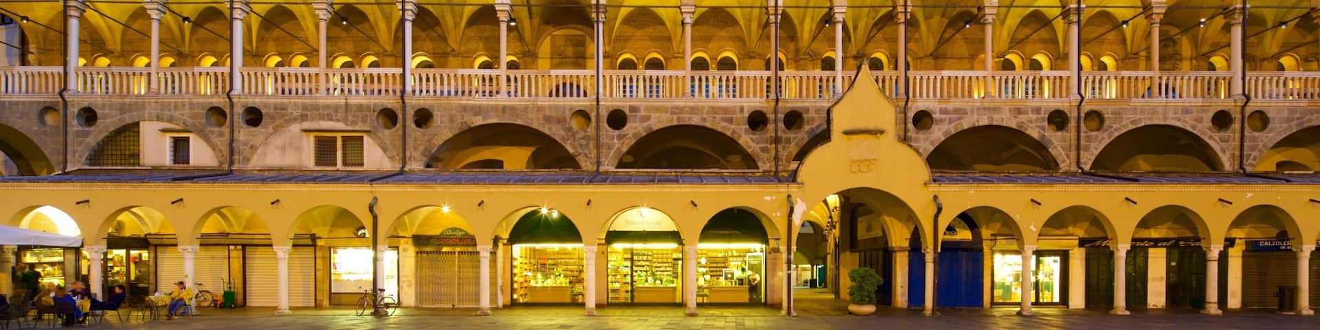 A historic building with multiple arches and a covered upper level.