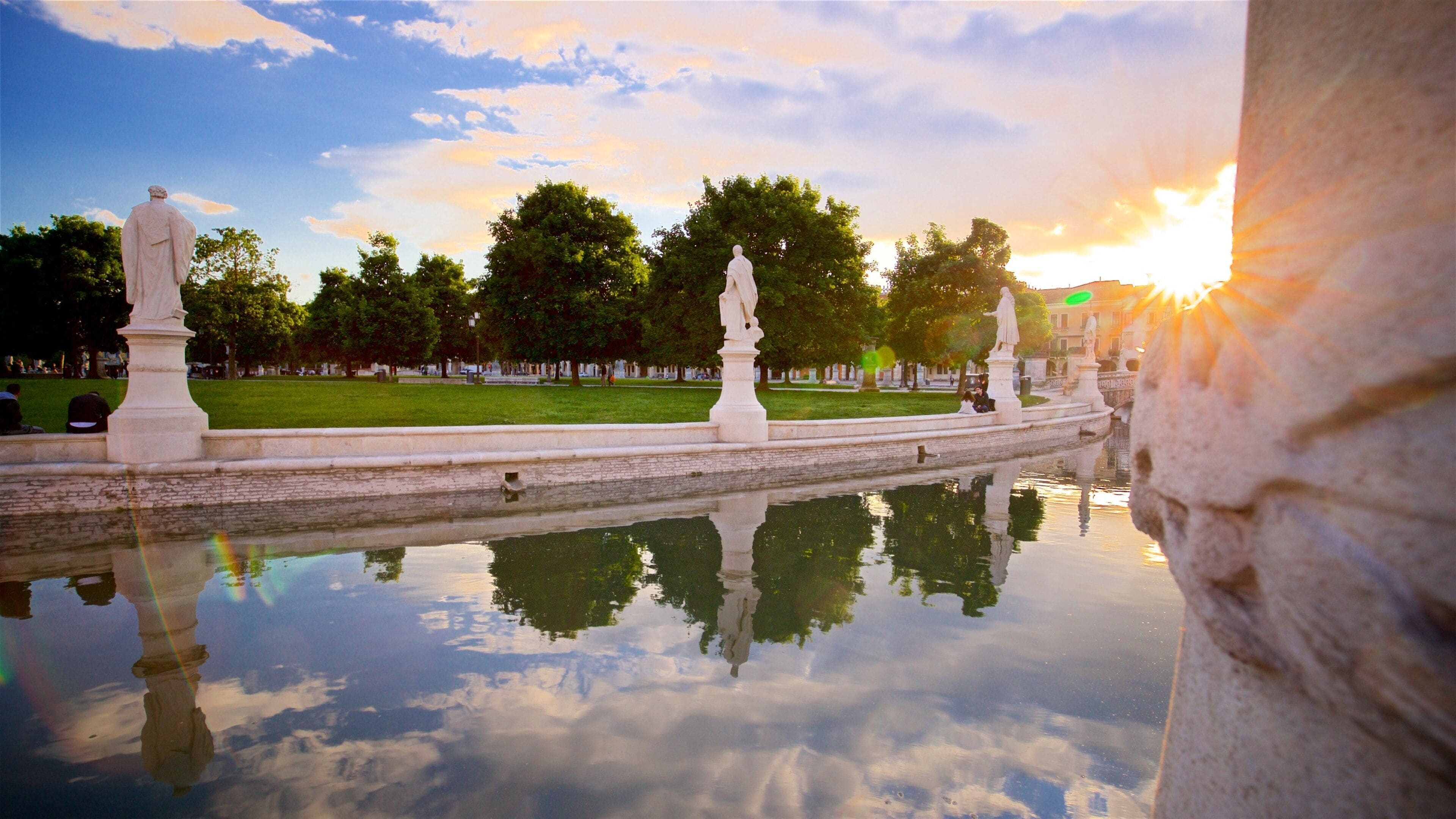 Prato della Valle which includes a garden, a sunset and a statue or sculpture