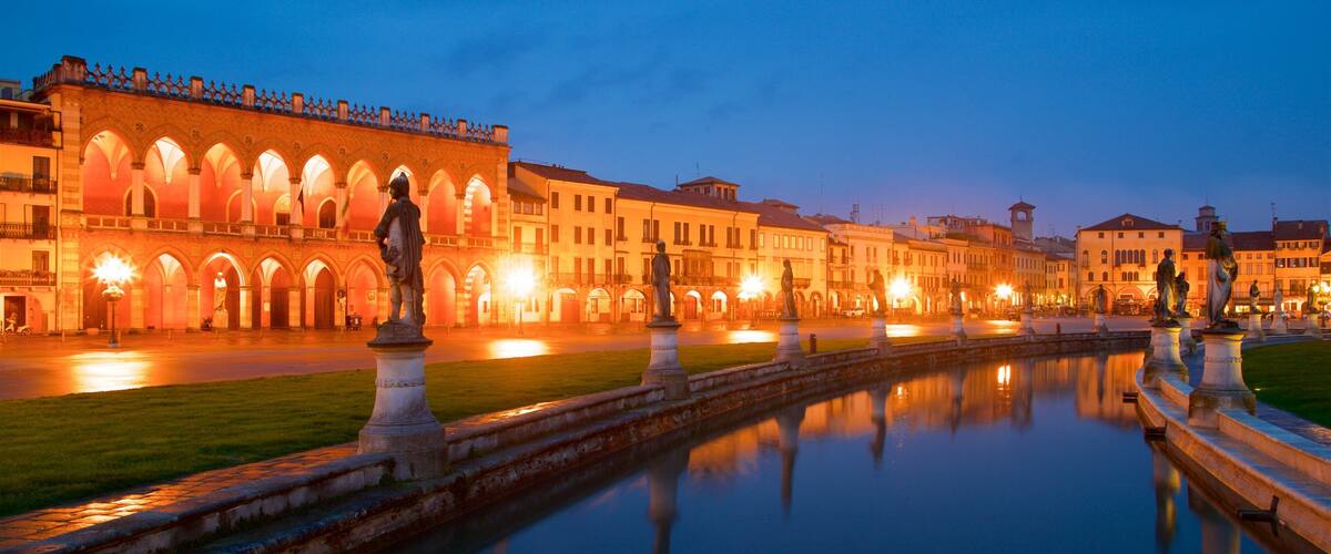Prato della Valle featuring a statue or sculpture, a park and night scenes