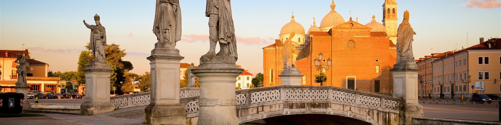 Prato della Valle featuring heritage architecture, a statue or sculpture and a sunset